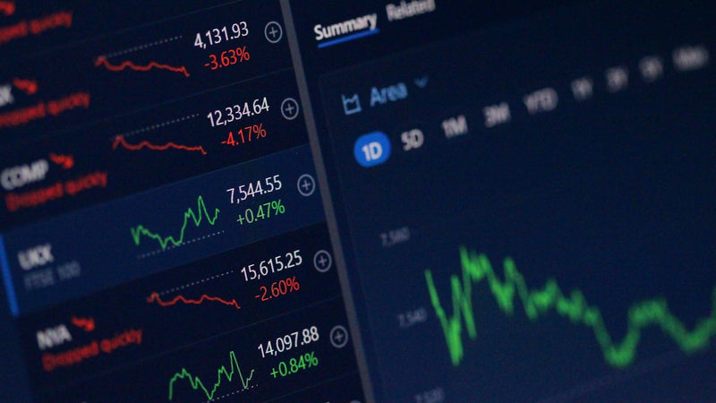 Market index quotes and a price chart on a screen. Photo by Anne Nygård on Unsplash.