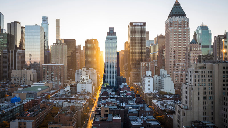 High-rise city skyline at sunrise. Photo by ben o'bro on Unsplash.