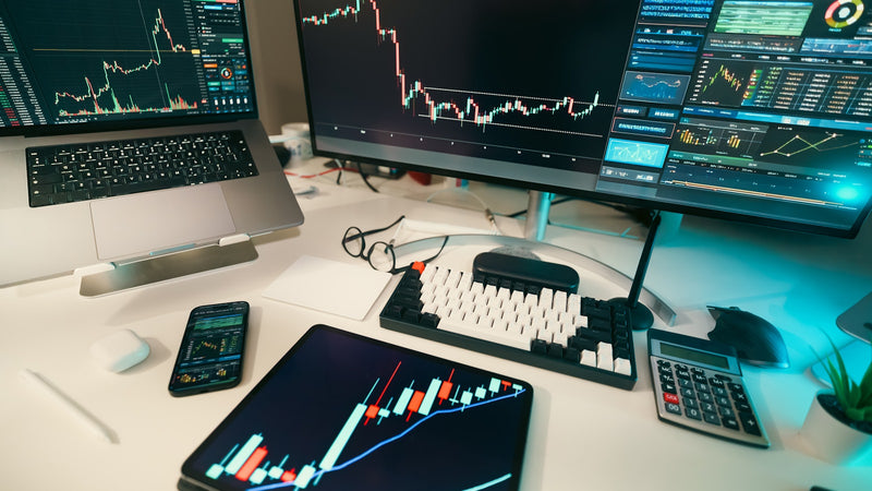 Stock charts displayed on multiple screens. Photo by Jakub Zerdzicki on Unsplash.