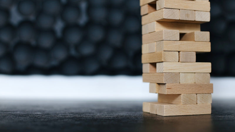 Tower of stacked wooden blocks. Photo by Valery Fedotov on Unsplash.